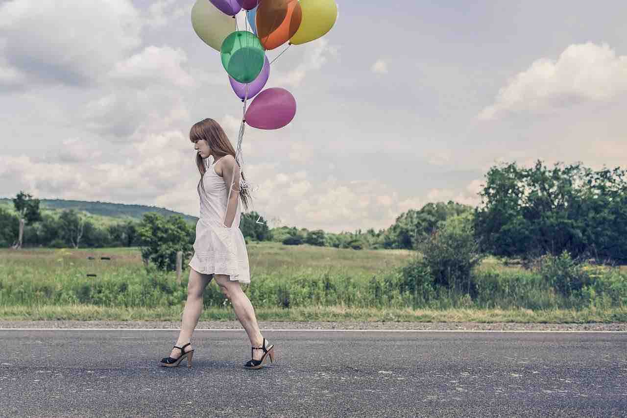 a woman carrying balloons
